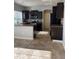 Open kitchen with dark cabinets, stainless steel appliances and tile floor at 5537 Malta St, Denver, CO 80249