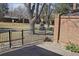 Backyard exterior view showing fence, trees and lawn at 6150 W Mansfield Ave # 33, Denver, CO 80235