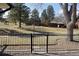 Backyard exterior featuring trees, gravel, grass and fence at 6150 W Mansfield Ave # 33, Denver, CO 80235