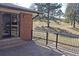 Exterior view of a backyard with fence, gravel, and mature trees at 6150 W Mansfield Ave # 33, Denver, CO 80235