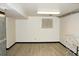 Finished basement featuring light wood plank flooring and a window with curtains at 6150 W Mansfield Ave # 33, Denver, CO 80235