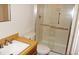 Bathroom featuring a glass-enclosed shower, toilet, and vanity with gold colored countertop at 6150 W Mansfield Ave # 33, Denver, CO 80235