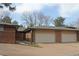 Brick home with attached garages and manicured lawn showcasing a traditional architectural design at 6150 W Mansfield Ave # 33, Denver, CO 80235