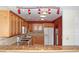 Well-lit kitchen featuring light-colored wood cabinetry, granite countertops, and modern appliances at 6150 W Mansfield Ave # 33, Denver, CO 80235