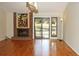 Bright living room featuring a brick fireplace, hardwood floors, and sliding glass doors to the yard at 6150 W Mansfield Ave # 33, Denver, CO 80235