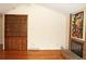 Spacious living room includes a built-in bookshelf, brick fireplace and gleaming hardwood floors at 6150 W Mansfield Ave # 33, Denver, CO 80235