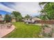 Fenced backyard with patio, green lawn, shed and RV parking at 4162 S Dunkirk Way, Aurora, CO 80013