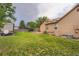 Spacious backyard with green lawn, patio, and mature trees at 4162 S Dunkirk Way, Aurora, CO 80013