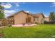 Backyard featuring a stamped concrete patio and a grassy lawn at 4162 S Dunkirk Way, Aurora, CO 80013