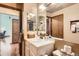 Bathroom boasts a bright vanity with ample storage and a view to another room, creating an open, inviting space at 4162 S Dunkirk Way, Aurora, CO 80013