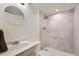 Bathroom featuring a shower with marble-look surround and a vanity sink at 4162 S Dunkirk Way, Aurora, CO 80013