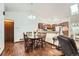 Dining area with wood floors, dining table, and a view into the kitchen at 4162 S Dunkirk Way, Aurora, CO 80013