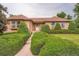 Charming single-Gathering home boasts a well-manicured lawn and mature landscaping at 4162 S Dunkirk Way, Aurora, CO 80013