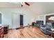 Cozy living room with wood floors, vaulted ceilings, and a skylight at 4162 S Dunkirk Way, Aurora, CO 80013