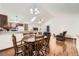 Open layout with dining area, kitchen, and living room featuring wood floors and ample natural light at 4162 S Dunkirk Way, Aurora, CO 80013