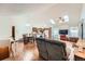 Open-concept living space features wood floors, skylights, and a combined dining/kitchen area at 4162 S Dunkirk Way, Aurora, CO 80013