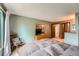 Bedroom featuring neutral paint, carpeting, a wall-mounted TV and en-suite bath access at 4162 S Dunkirk Way, Aurora, CO 80013