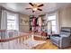 Cozy Bedroom with natural light, featuring hardwood floors and ample closet storage at 835 Lewis Dr, Lakewood, CO 80215