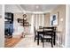 Cozy dining area adjacent to living room featuring a table with chairs and natural lighting at 835 Lewis Dr, Lakewood, CO 80215