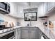 Bright kitchen featuring white cabinets, stainless steel appliances and a stylish herringbone backsplash at 835 Lewis Dr, Lakewood, CO 80215