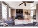 Comfortable living room featuring a fireplace, ceiling fan, large window, and adjoining dining area at 835 Lewis Dr, Lakewood, CO 80215