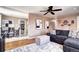 Spacious living room featuring a large sectional couch, modern artwork, and an adjacent dining area at 835 Lewis Dr, Lakewood, CO 80215
