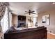 Inviting living room with a modern fireplace, ceiling fan, and cozy, neutral-toned furniture at 835 Lewis Dr, Lakewood, CO 80215