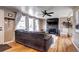 Cozy living room with hardwood floors, fireplace, modern decor, and ample natural light at 835 Lewis Dr, Lakewood, CO 80215