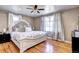 Inviting main bedroom with hardwood floors, large windows, and a beautifully upholstered bed at 835 Lewis Dr, Lakewood, CO 80215