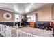 Functional home office with natural light, ample desk space, and a dedicated exercise area at 835 Lewis Dr, Lakewood, CO 80215