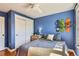Blue bedroom with wood floors, window and closet at 3386 Beeler Ct, Denver, CO 80238