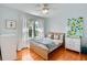 Bright bedroom with light wood floors and trim, large window and stylish decor at 3386 Beeler Ct, Denver, CO 80238