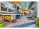 Well-designed outdoor deck with comfortable seating, a table, and a green lawn in a fenced-in yard at 3386 Beeler Ct, Denver, CO 80238