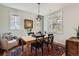 Bright dining room with a wooden table, black chairs, rug, and natural lighting at 3386 Beeler Ct, Denver, CO 80238