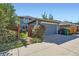 View of garage and fenced-in yard with a well-maintained lawn, all contributing to attractive curb appeal at 3386 Beeler Ct, Denver, CO 80238