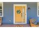 Inviting yellow front door with decorative wreath, leading to a stylish and well-maintained home at 3386 Beeler Ct, Denver, CO 80238