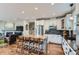 Modern kitchen with white cabinets, stainless appliances, wood floors, and island with seating at 3386 Beeler Ct, Denver, CO 80238