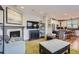 Open-concept living room with fireplace seamlessly connecting to the kitchen, ideal for entertaining and Gathering gatherings at 3386 Beeler Ct, Denver, CO 80238