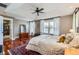 Spacious main bedroom with tray ceiling, hardwood floors, and large windows at 3386 Beeler Ct, Denver, CO 80238