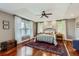 Bedroom with tray ceiling, hardwood floors, large windows, and traditional furnishings at 3386 Beeler Ct, Denver, CO 80238