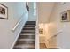 Carpeted staircase with white railing leading to upper and lower levels at 3386 Beeler Ct, Denver, CO 80238