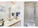 Bathroom featuring a shower-tub combination, soft natural light from the window, and neutral-toned vanity at 1079 S Walden Way # 217, Aurora, CO 80017