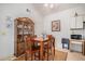 Cozy dining room featuring a wooden table set, elegant china cabinet, and warm natural light at 1079 S Walden Way # 217, Aurora, CO 80017