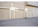 Row of individual car garages with neutral-toned doors in a well-maintained community at 1079 S Walden Way # 217, Aurora, CO 80017