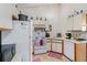 Bright kitchen with white cabinetry, standard appliances, and efficient layout, ideal for meal preparation at 1079 S Walden Way # 217, Aurora, CO 80017