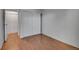 A bright bedroom with wood-look floors and a spacious closet with folding doors at 1300 Golden Cir # 111, Golden, CO 80401