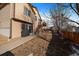 Walkway leads to a spacious backyard with stairs to upper deck at 12590 Prince Creek Dr, Parker, CO 80134