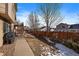 Backyard with wooden fence, patio, and walkway at 12590 Prince Creek Dr, Parker, CO 80134