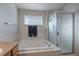 Clean bathroom with a bathtub and a shower at 12590 Prince Creek Dr, Parker, CO 80134