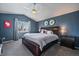 Main bedroom with dark wood furniture, ceiling fan, and blue walls at 12590 Prince Creek Dr, Parker, CO 80134